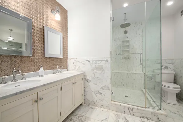 a bathroom with a shower sink and mirror