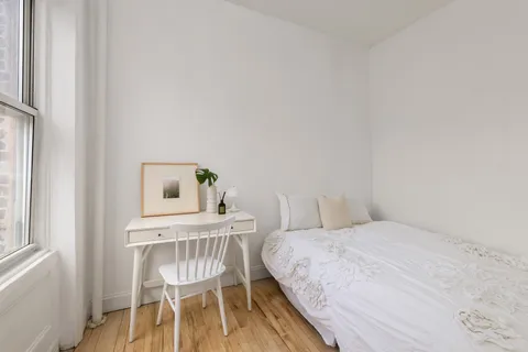 a bedroom with a bed and a chair