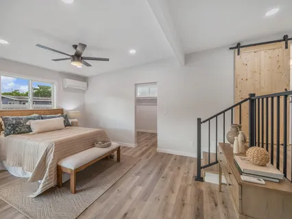 a bedroom with a bed and a chandelier