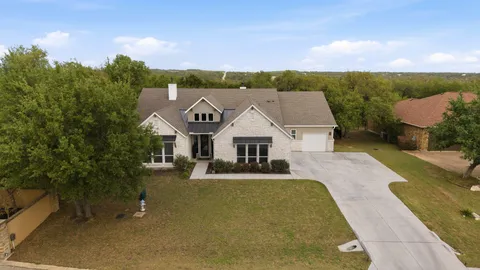 an aerial view of a house with a big yard