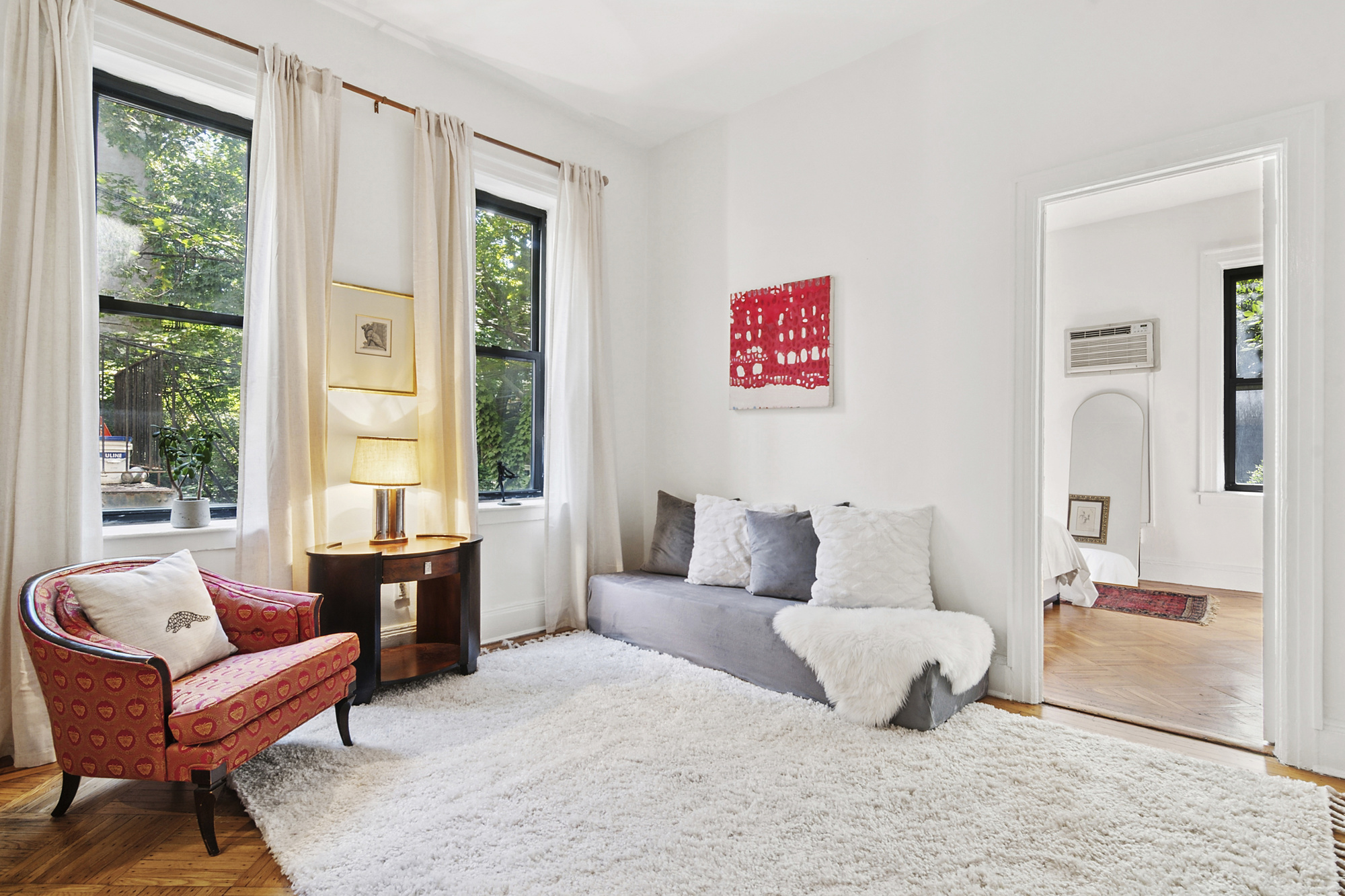 a living room with furniture and a large window