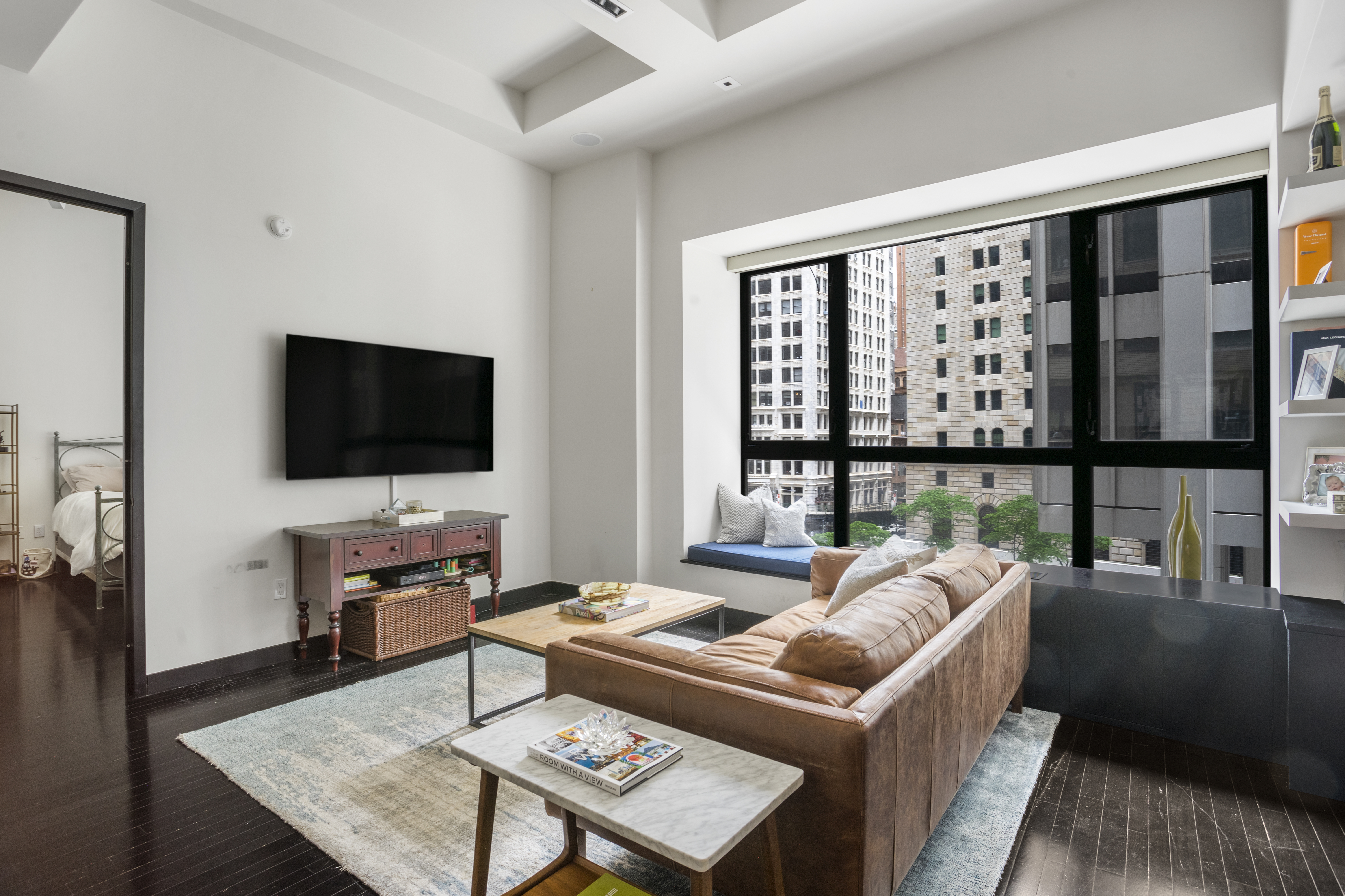 20 Pine Street, Unit 409 Manhattan, NY 10005 - Photo 2 of 11 a living room with furniture and a flat screen tv