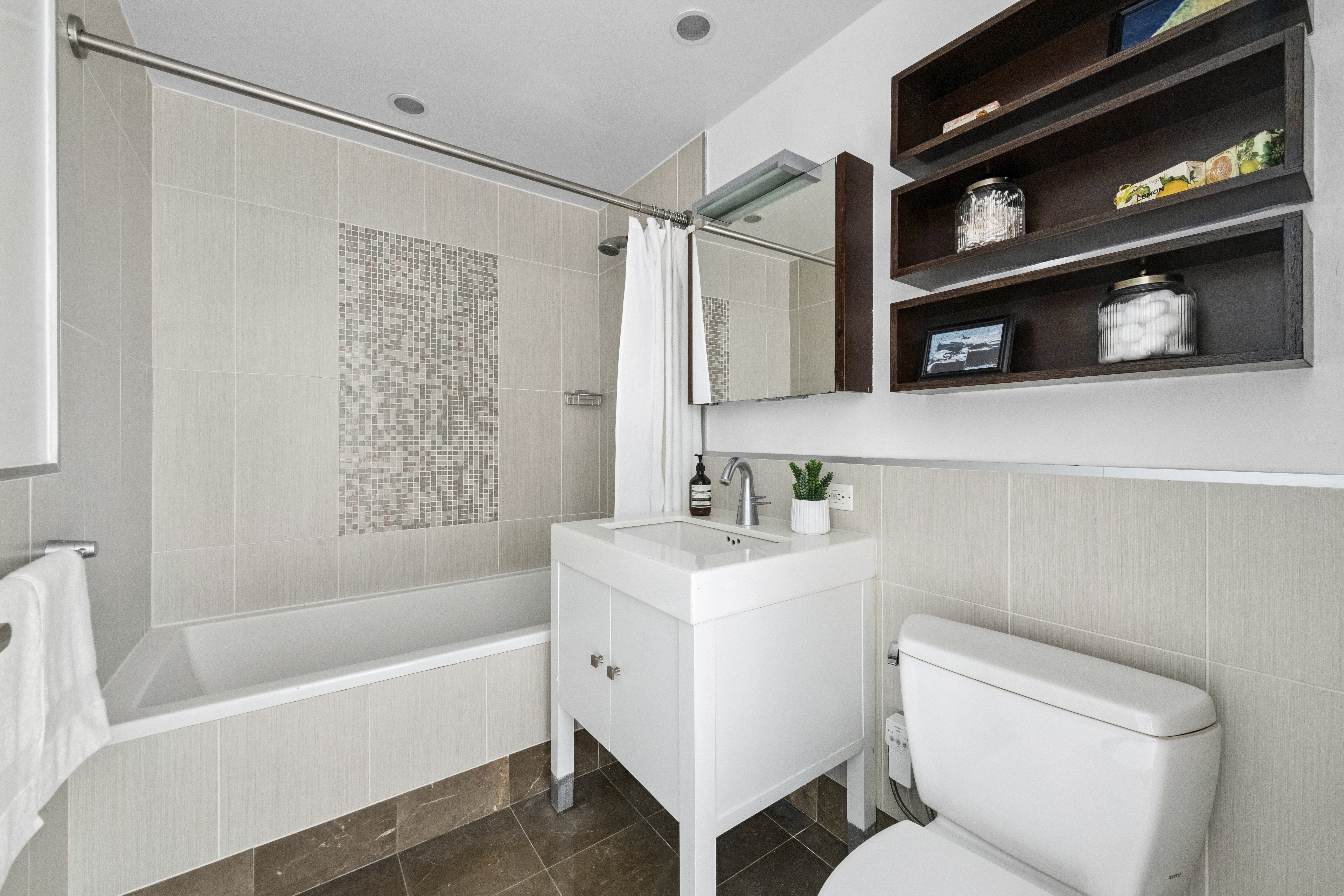 225 East 34th Street, Unit 5E Manhattan, NY 10016 - Photo 10 of 23 a bathroom with a sink a toilet and shower