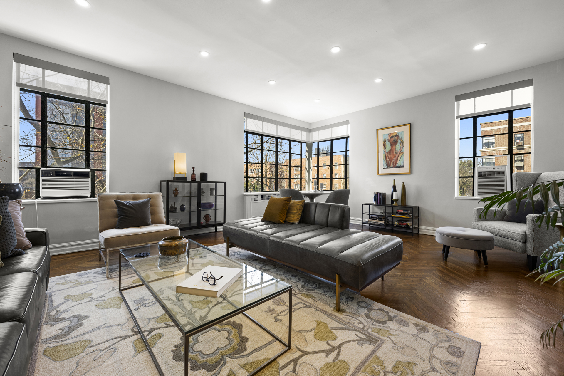 a living room with furniture and floor to ceiling windows