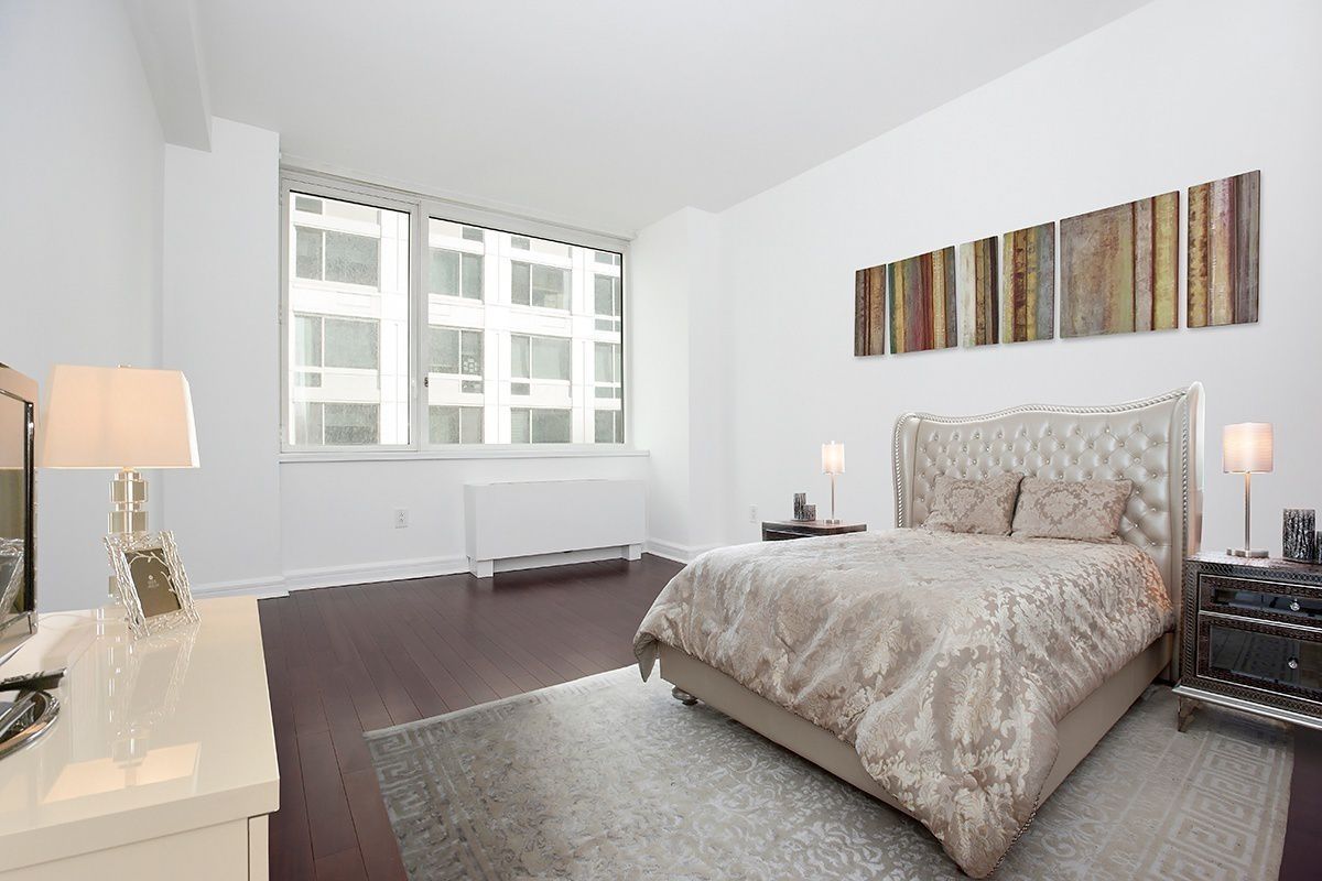 100 Riverside Boulevard, Unit 9D Manhattan, NY 10069 - Photo 2 of 13 a bedroom with a bed and a couch