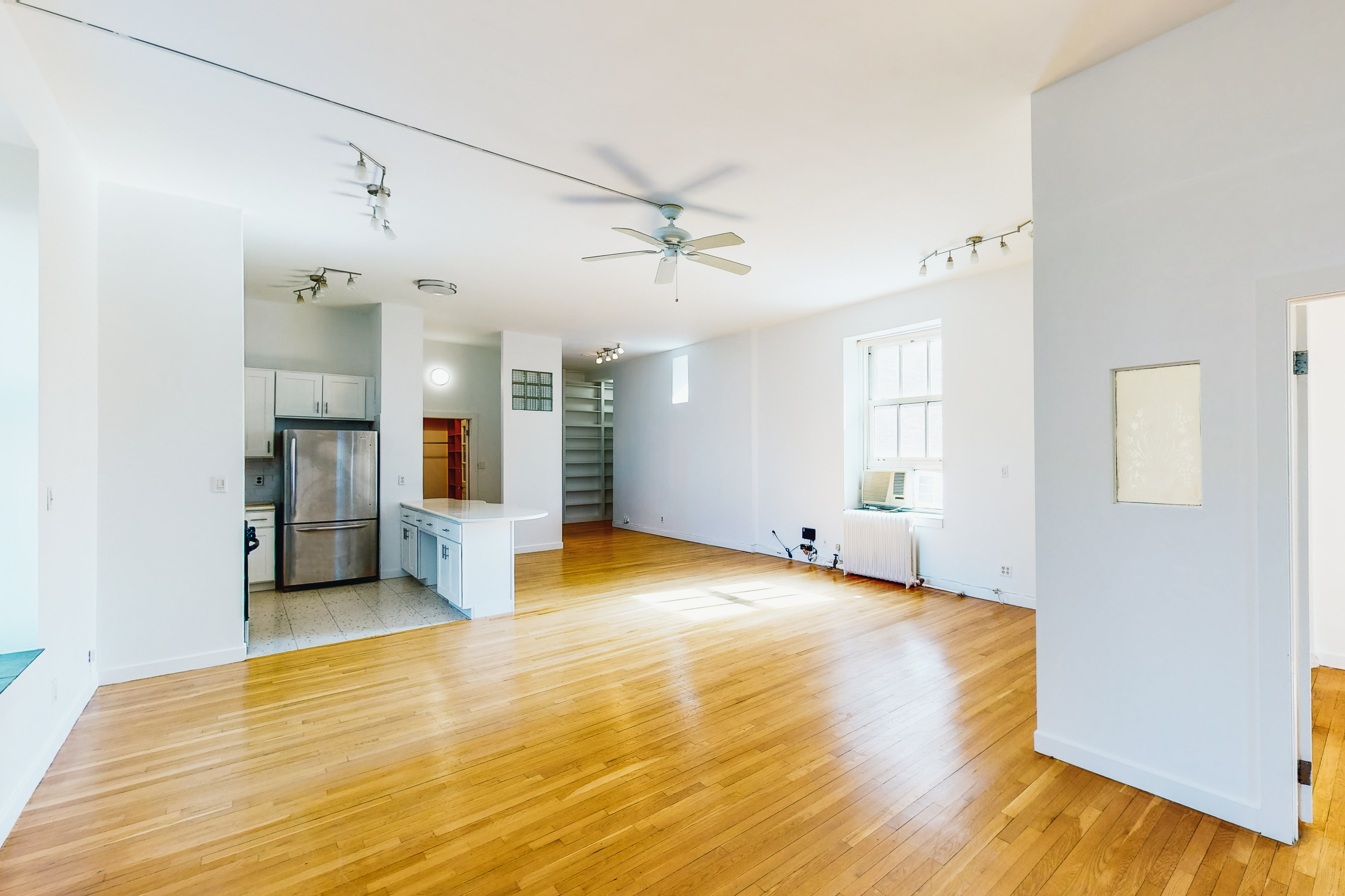 395 Broadway, Unit 7E Manhattan, NY 10013 - Photo 3 of 7 a view of a livingroom with a chandelier and wooden floor