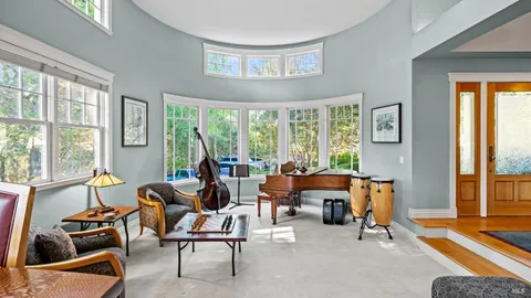 a living room with furniture and floor to ceiling windows