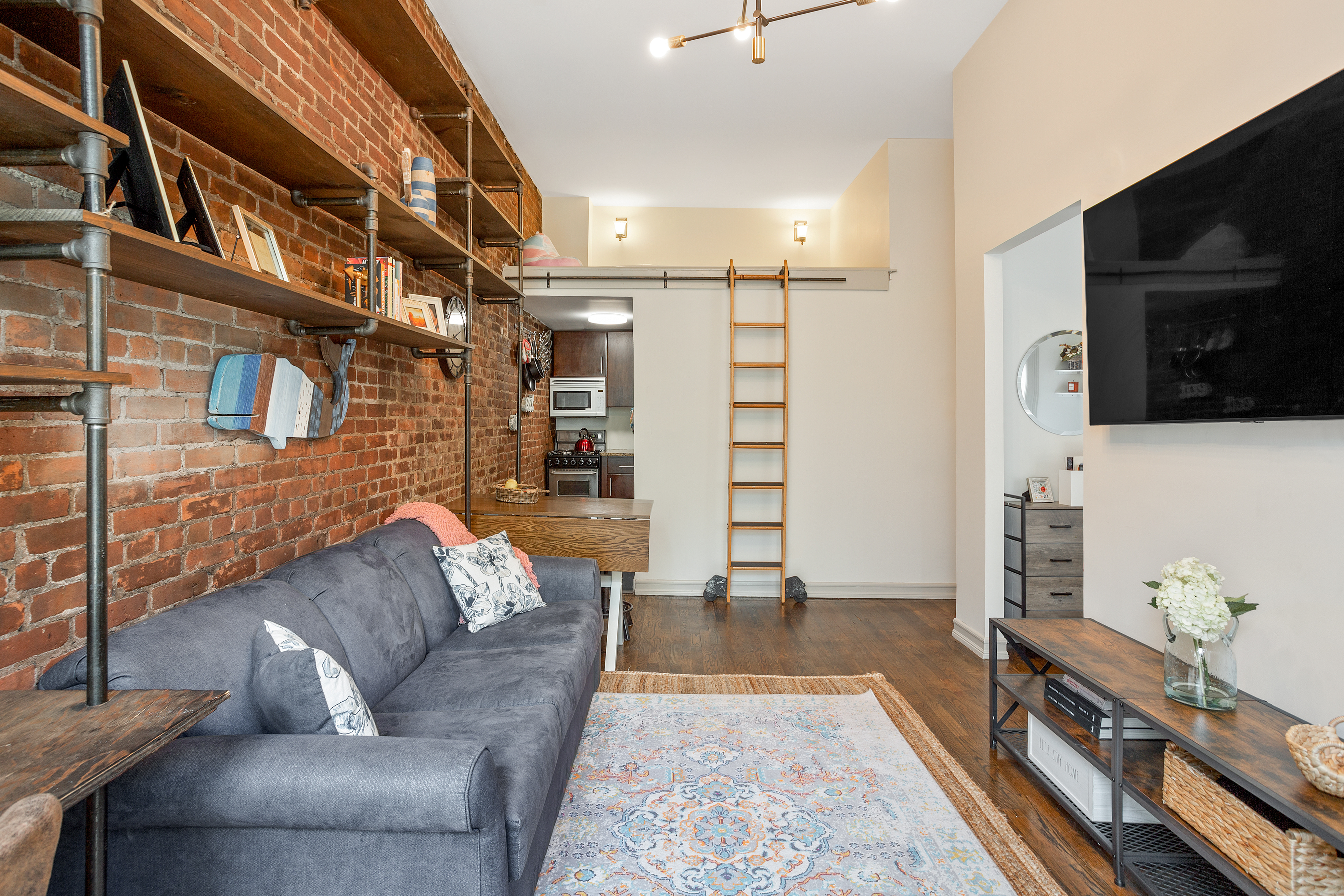 55 West 84th Street, Unit 5 Manhattan, NY 10024 - Photo 6 of 8 a living room with furniture and a flat screen tv