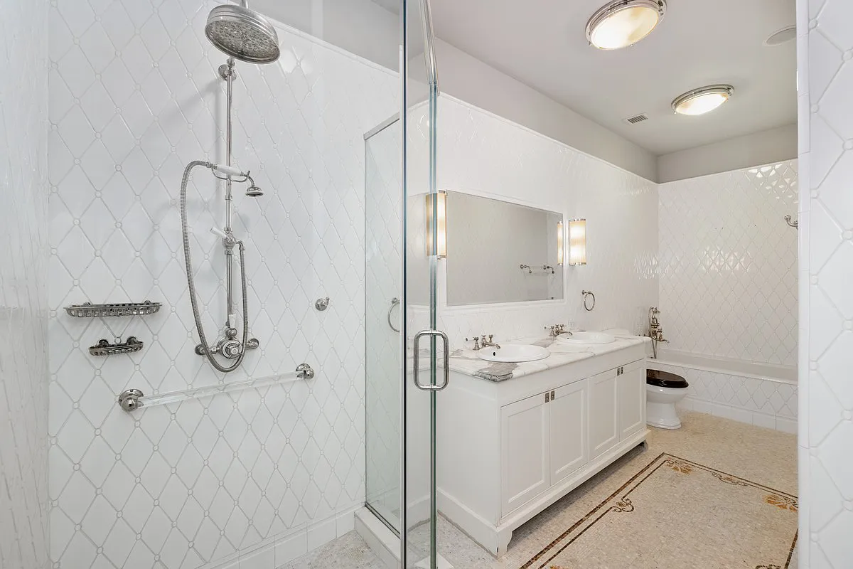 1 Central Park South, Unit 606 Manhattan, NY 10019 - Photo 9 of 13 a bathroom with a granite countertop sink a mirror and shower