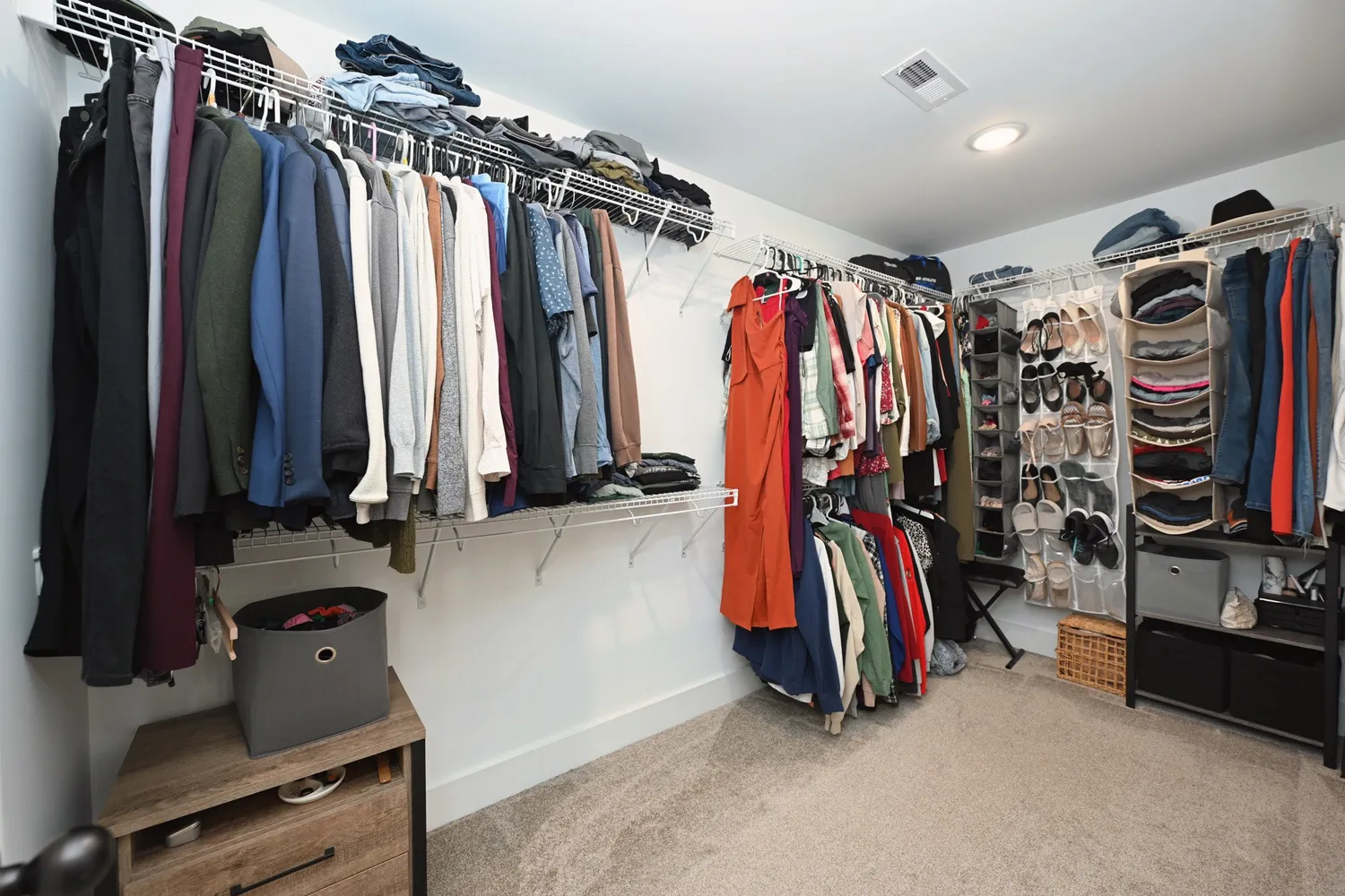 a view of walk in closet with clothes