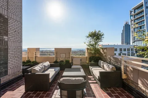 a balcony with furniture and city view