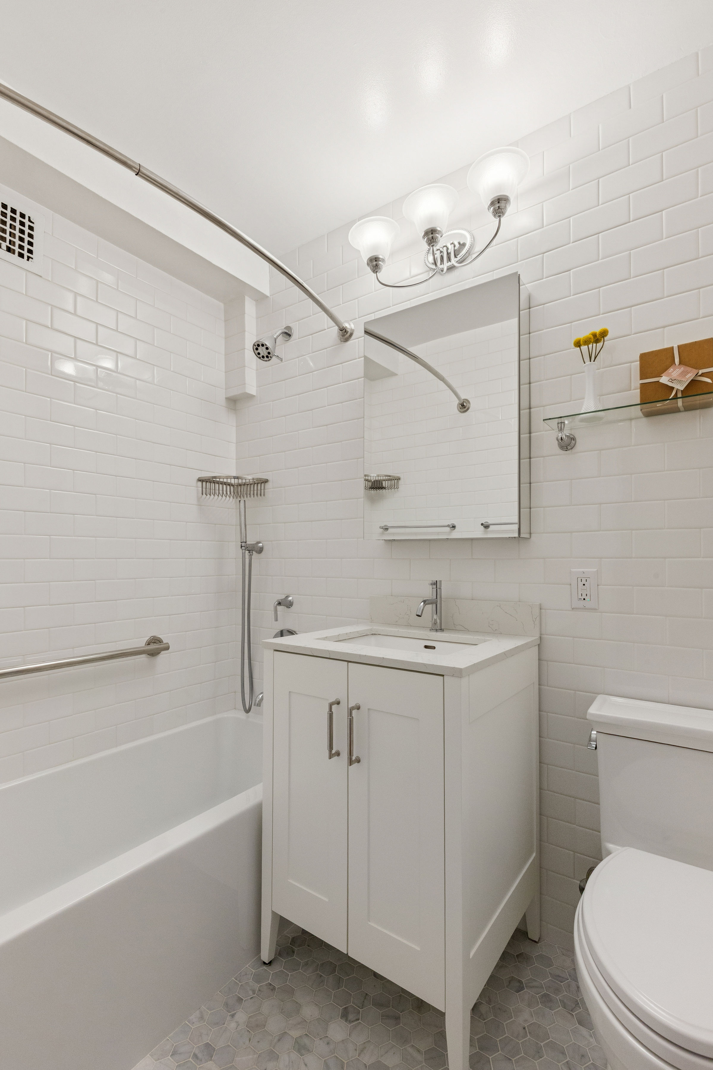 301 East 69th Street, Unit 14A Manhattan, NY 10021 - Photo 6 of 13 a bathroom with a sink a toilet and shower