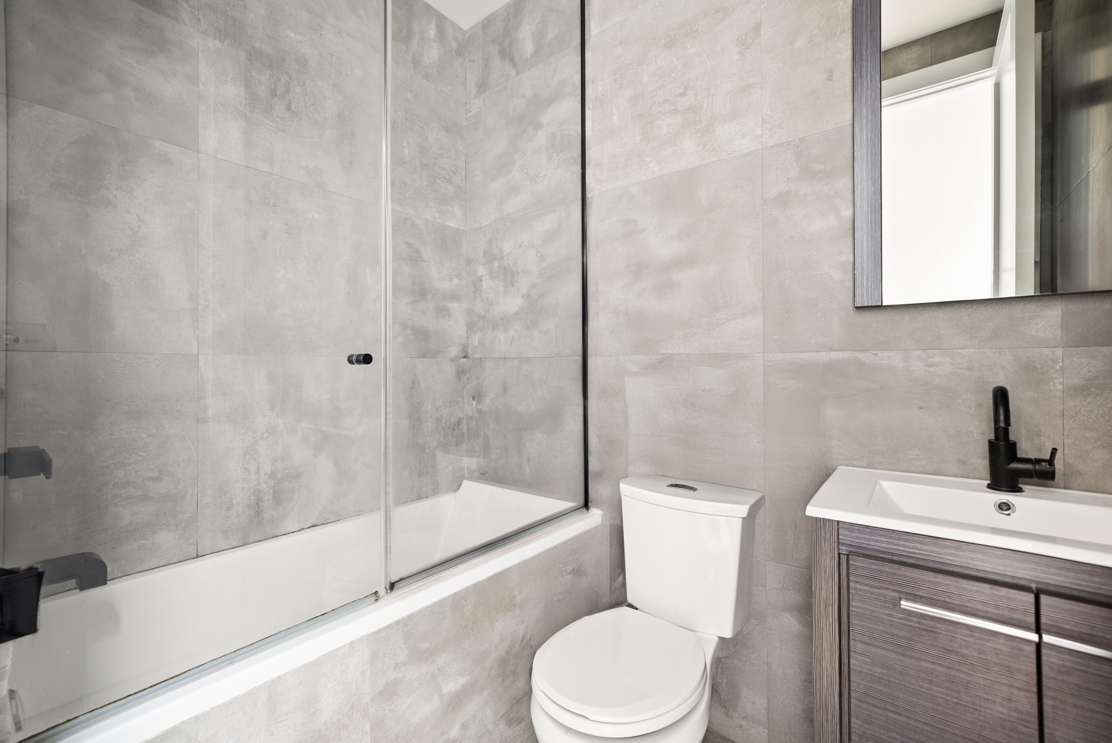 275 Bleecker Street, Unit 4 Manhattan, NY 10014 - Photo 7 of 10 a bathroom with a toilet a sink and bathtub