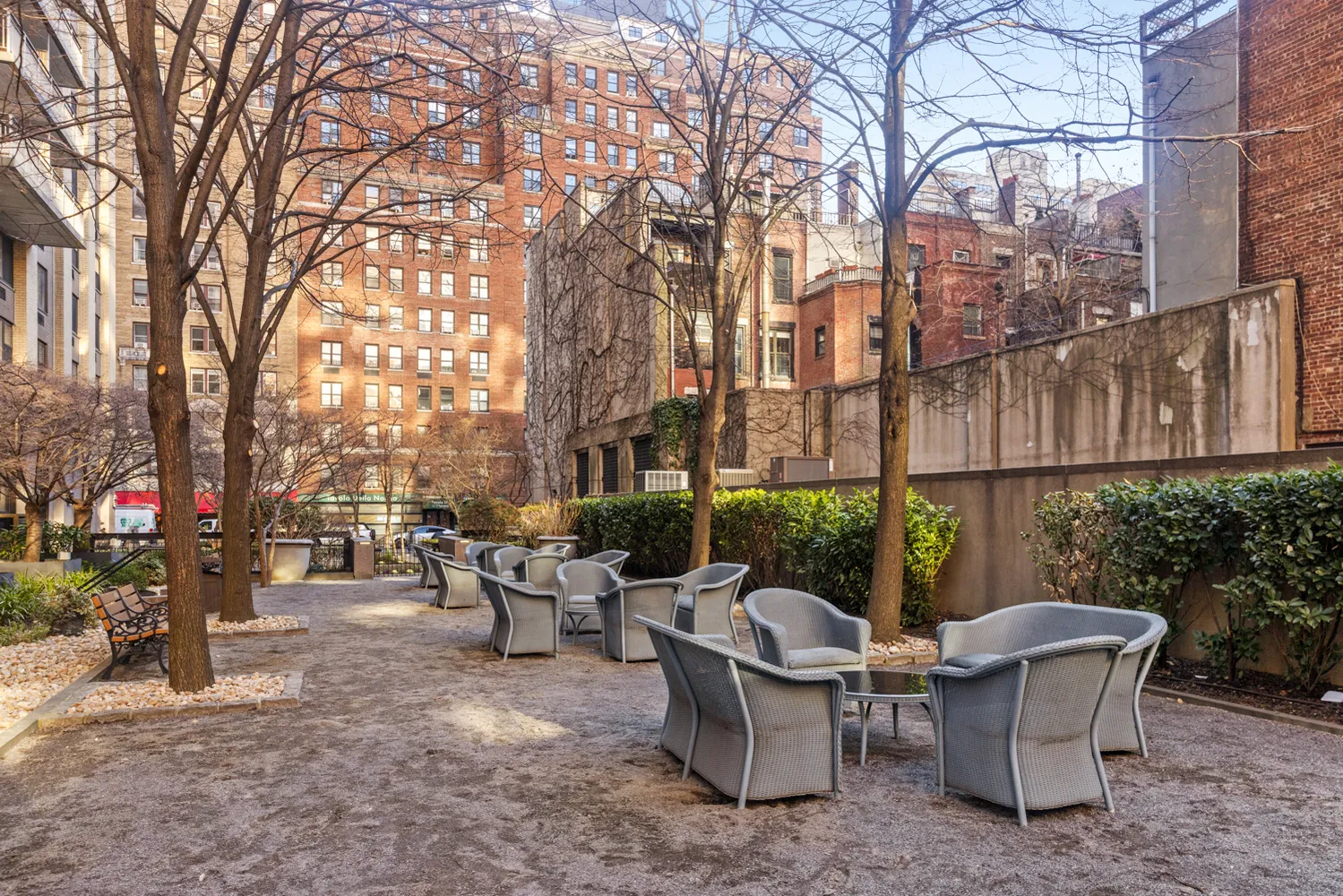 a view of a patio with couches and table and chairs and potted plants