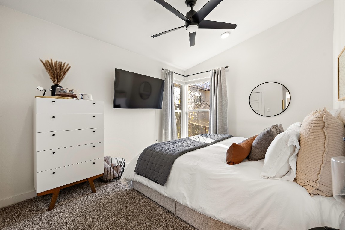 1402 Singleton Avenue, Unit B Austin, TX 78702 - Photo 17 of 26 a bedroom with a bed and a flat screen tv