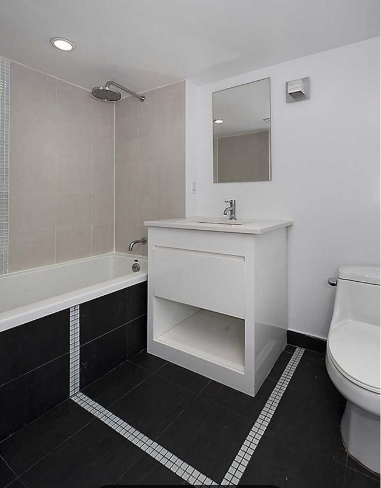 105 Grand Avenue, Unit 4L Brooklyn, NY 11205 - Photo 5 of 10 a bathroom with a sink toilet and mirror
