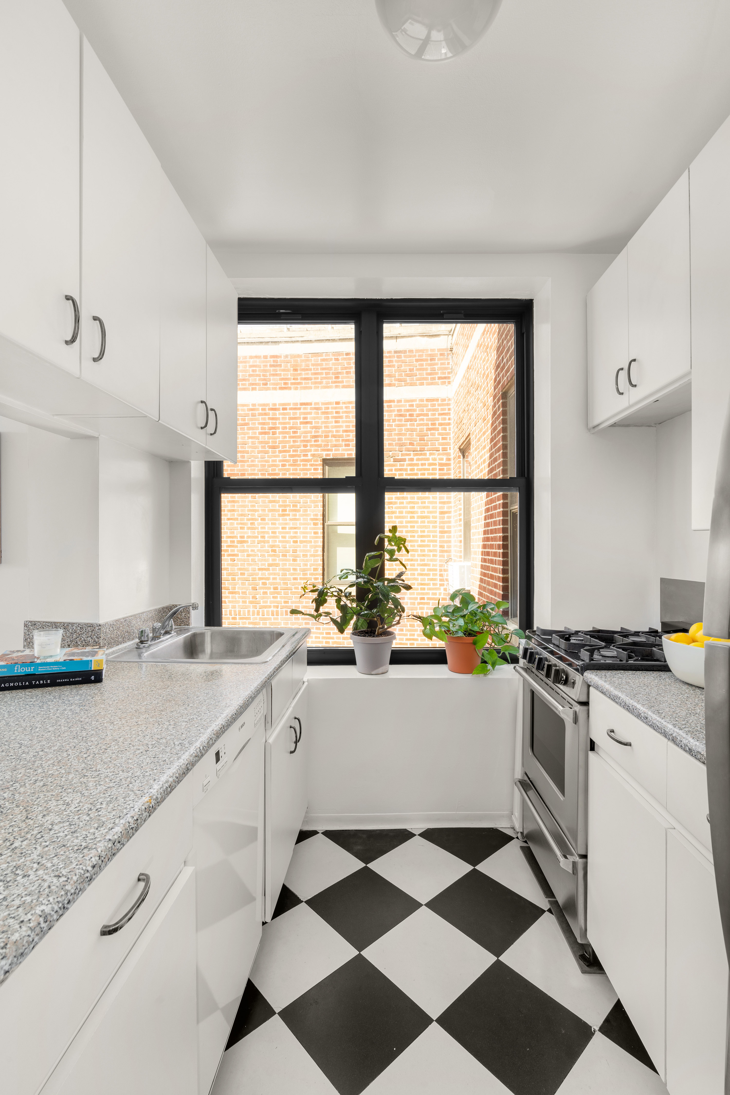 115 Eastern Parkway, Unit 6F Brooklyn, NY 11238 - Photo 4 of 11 a kitchen with a stove a sink and a window