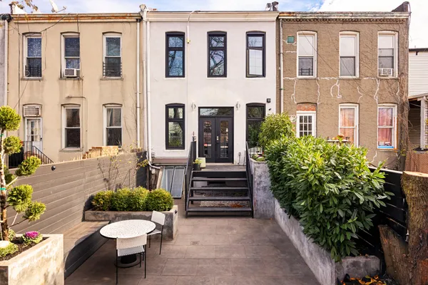 a view of a patio with couches chairs and potted plants