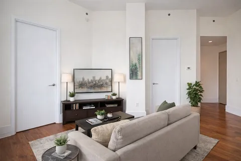a living room with furniture and wooden floor