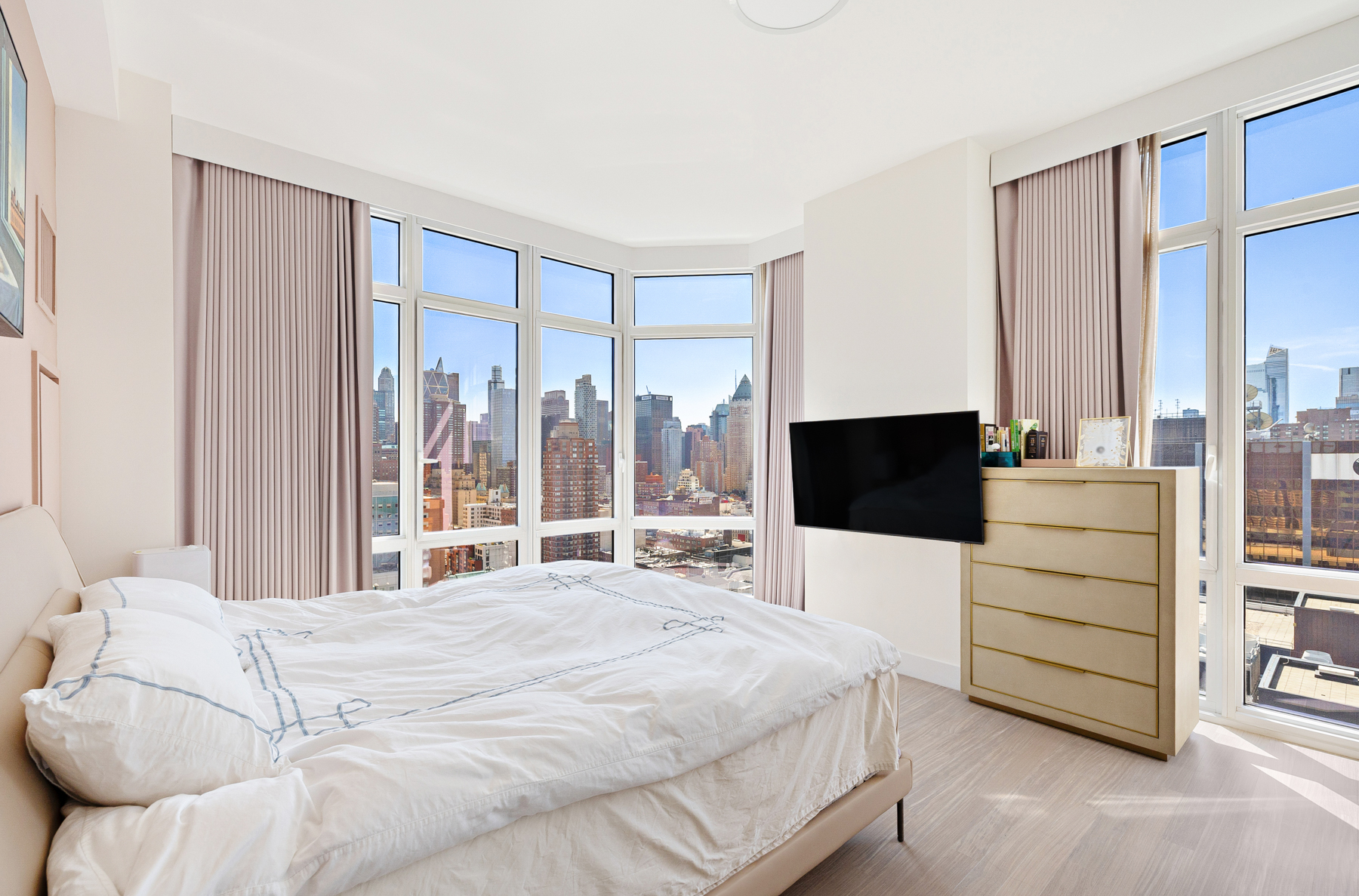 10 West End Avenue, Unit 30C Manhattan, NY 10023 - Photo 10 of 22 a bedroom with a bed and large window