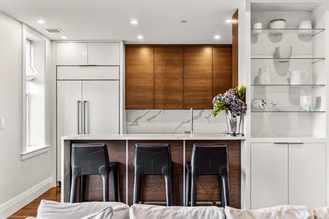 a kitchen with kitchen island a sink stainless steel appliances and cabinets