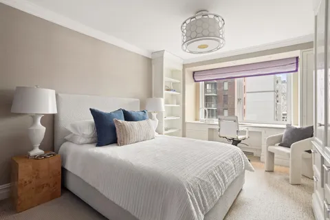 a bedroom with bed and a window