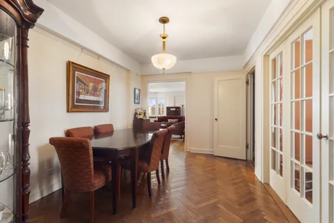 a view of a a dining room with furniture window and wooden floor