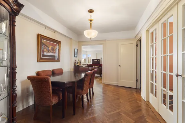 a view of a a dining room with furniture window and wooden floor