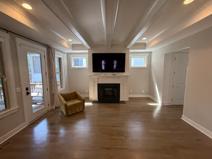 a living room with furniture a flat screen tv and a fireplace