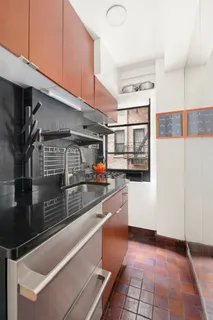 a kitchen with stainless steel appliances kitchen island granite countertop a sink and cabinets