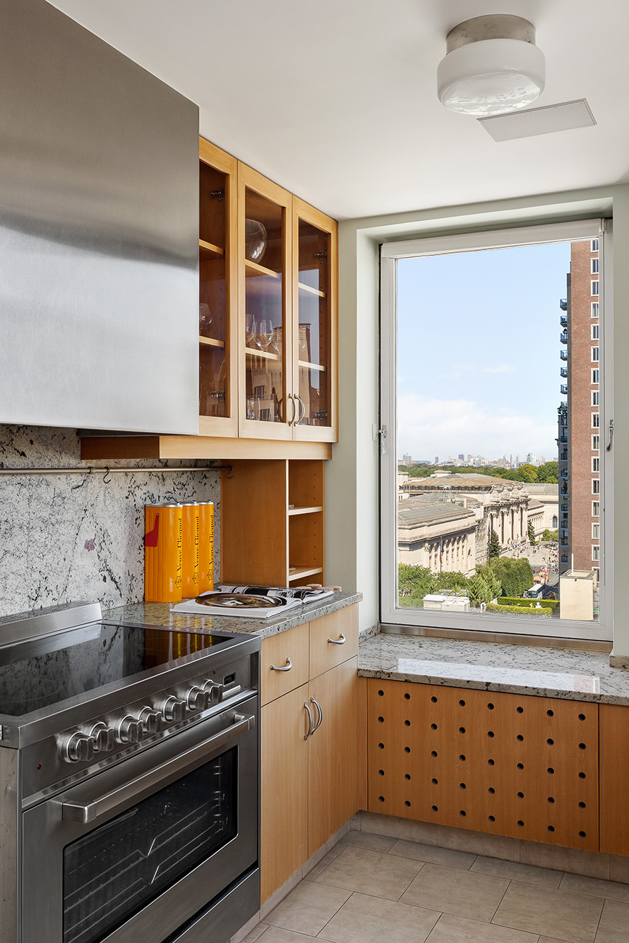 969 5th Avenue, Unit 14 Manhattan, NY 10075 - Photo 14 of 17 a kitchen with granite countertop a stove and a wooden floor