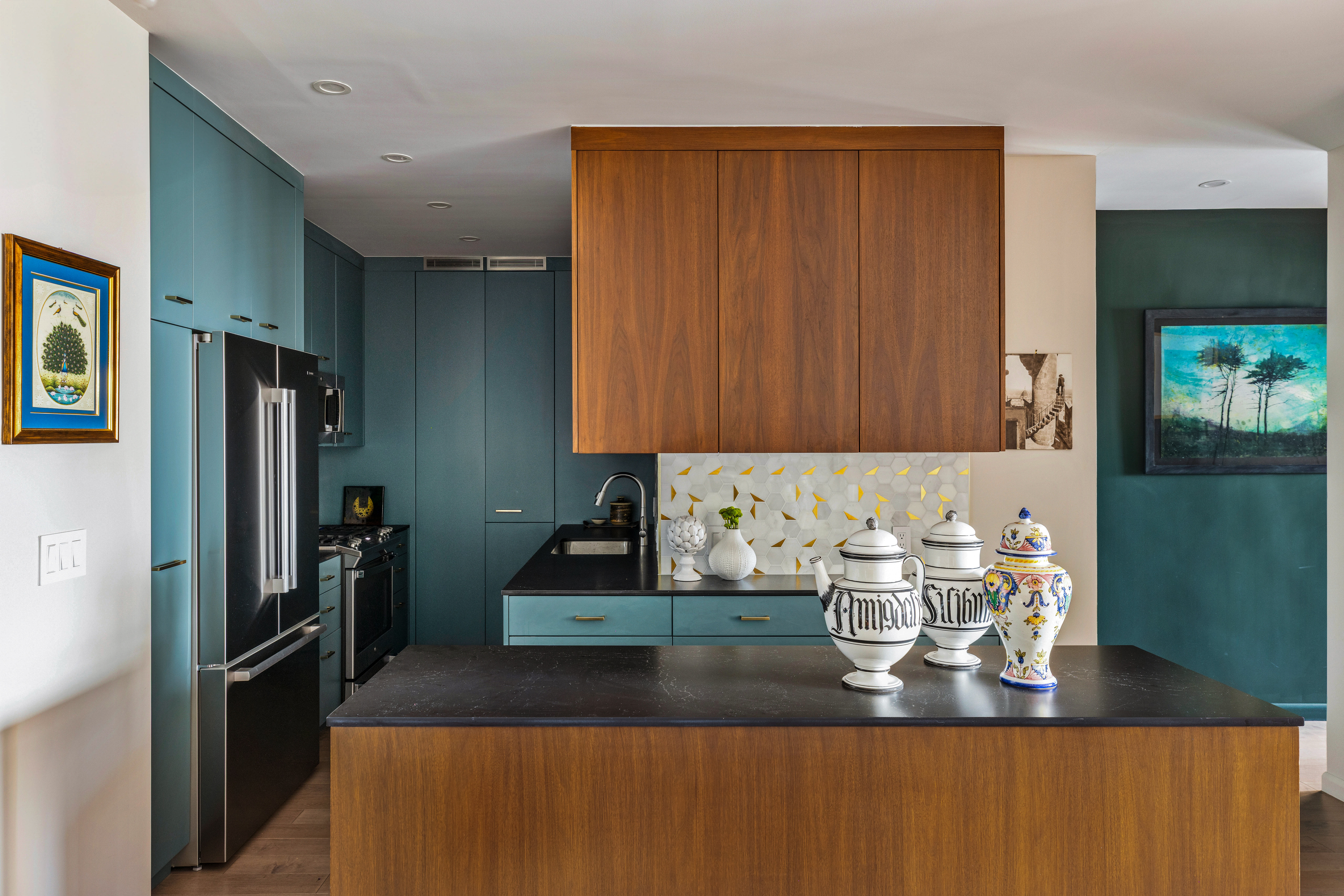 60 East 8th Street, Unit 30F Manhattan, NY 10003 - Photo 4 of 11 a kitchen with granite countertop stainless steel appliances a refrigerator and a counter top space