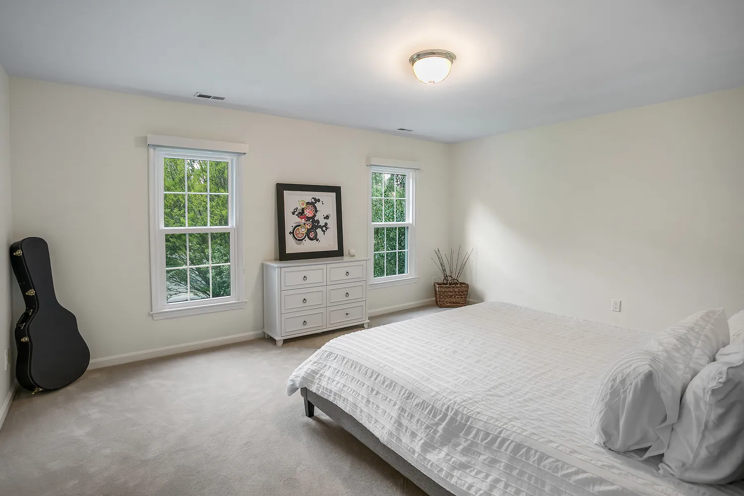 a bedroom with a bed and a large window