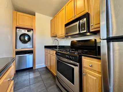 a kitchen with a stove microwave and cabinets