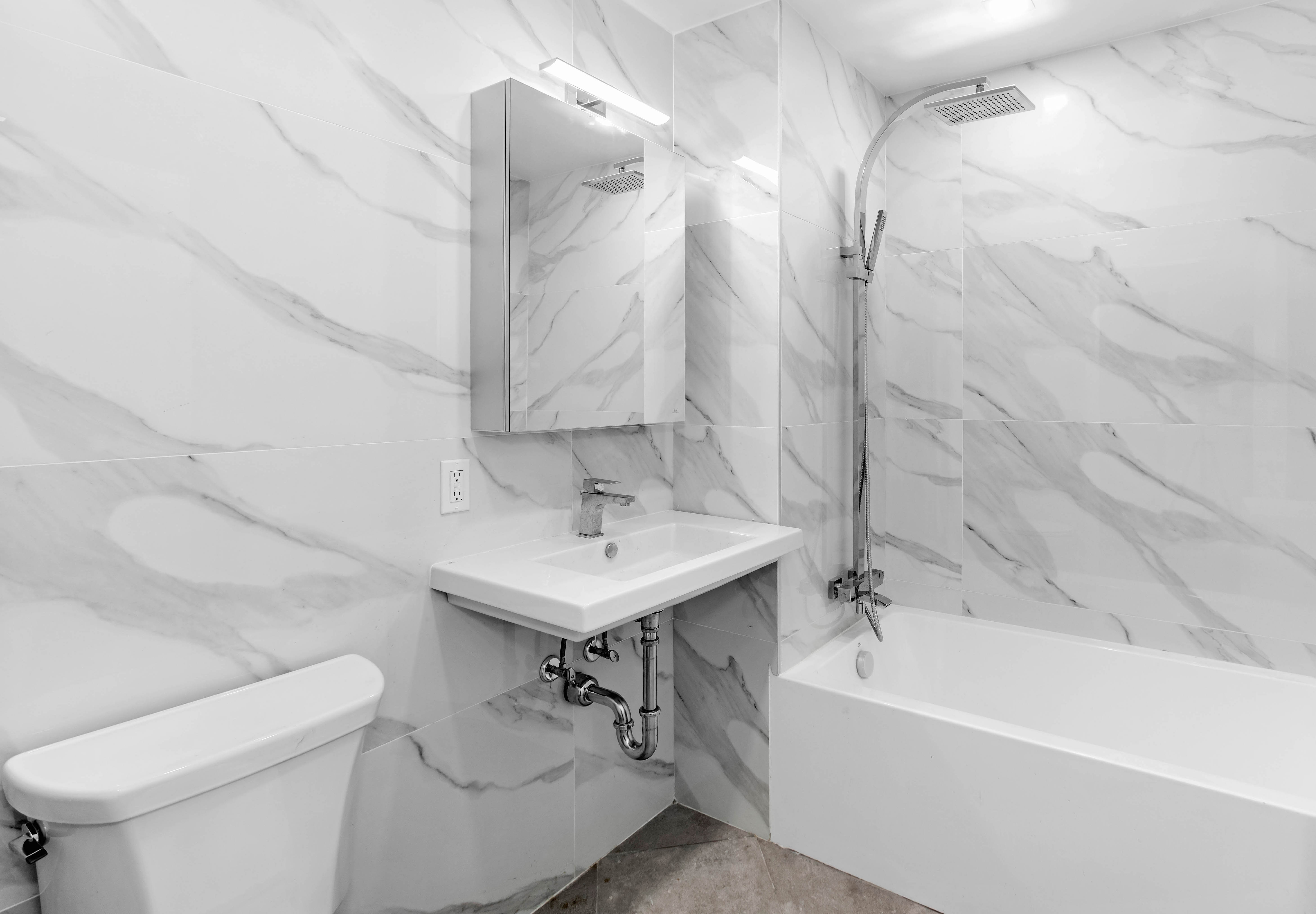 319 Broadway, Unit 6B Brooklyn, NY 11211 - Photo 5 of 5 a bathroom with a sink a toilet and bathtub