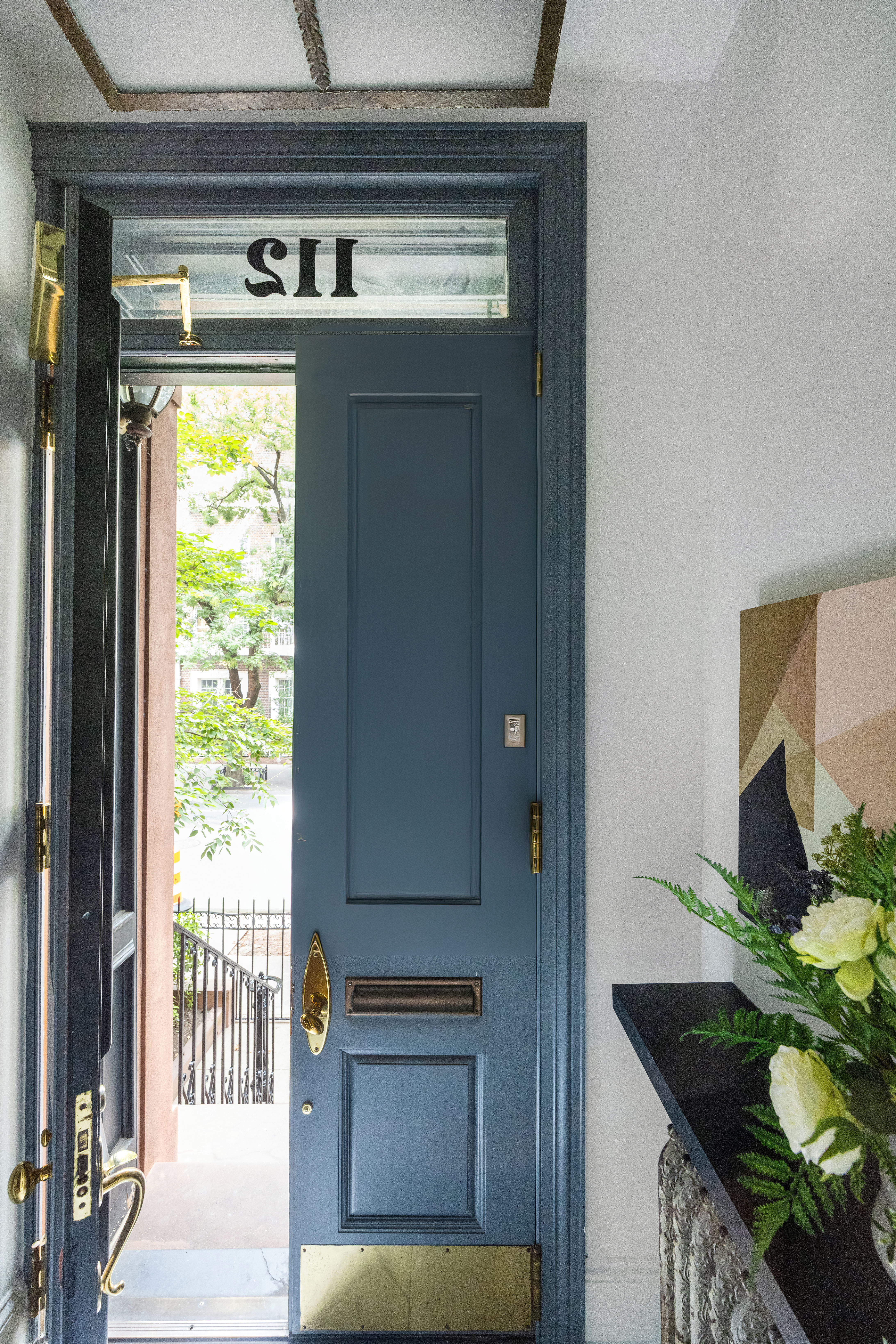 112 West 13th Street Manhattan, NY 10011 - Photo 5 of 46 a living room with a large window and a potted plant