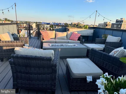 a terrace with outdoor seating and city view