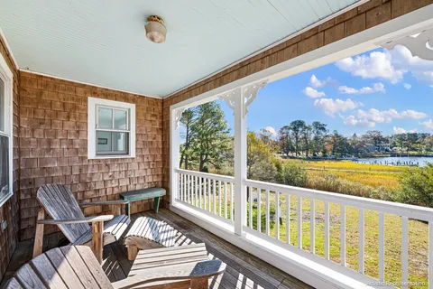 an aerial view of a house with swimming pool and porch