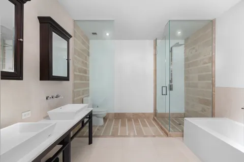 a bathroom with a sink toilet vanity and bathtub