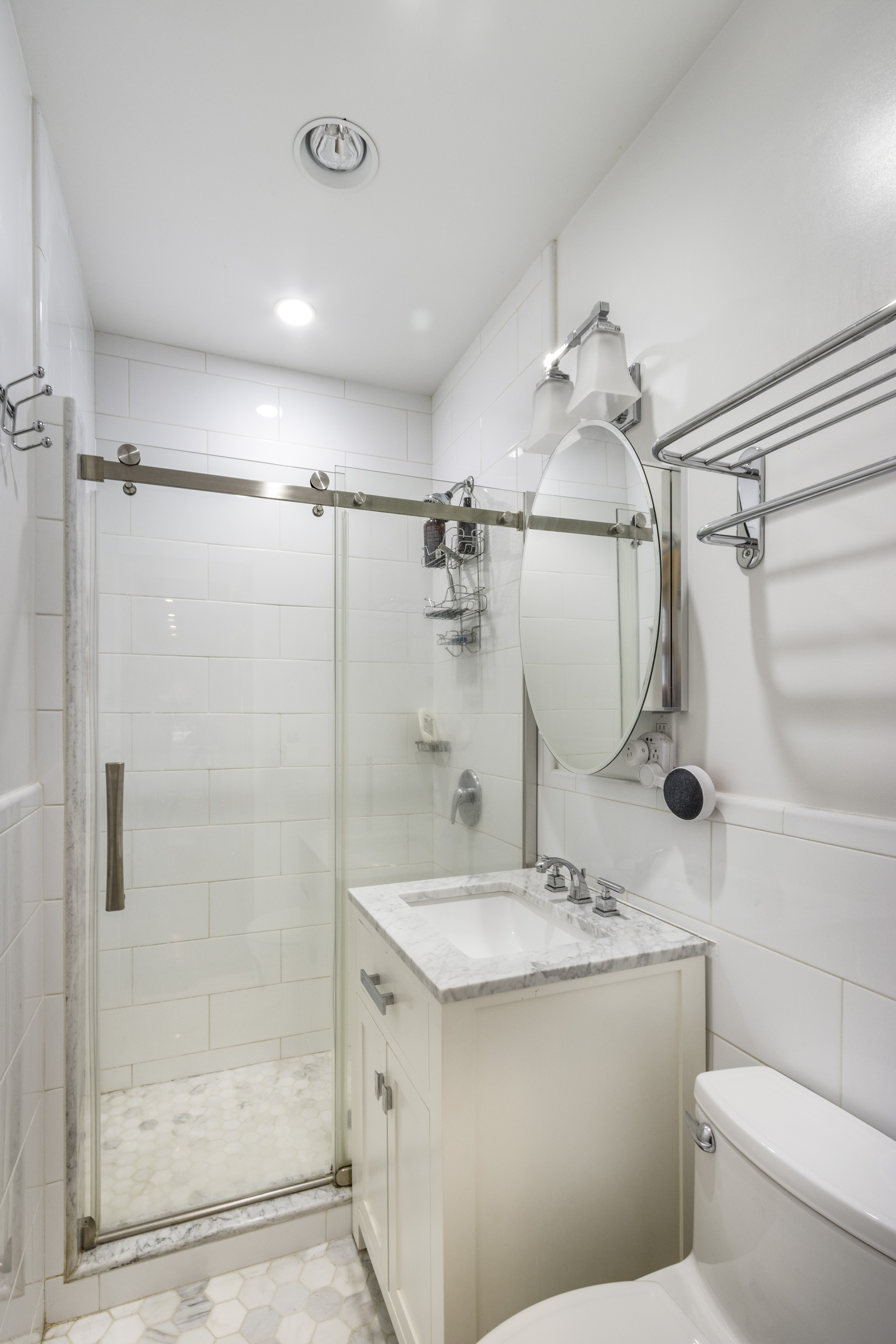160 East 74th Street, Unit 3 Manhattan, NY 10021 - Photo 4 of 12 a bathroom with a granite countertop sink toilet and shower