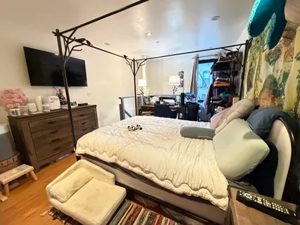 a bedroom with a bed and flat screen tv