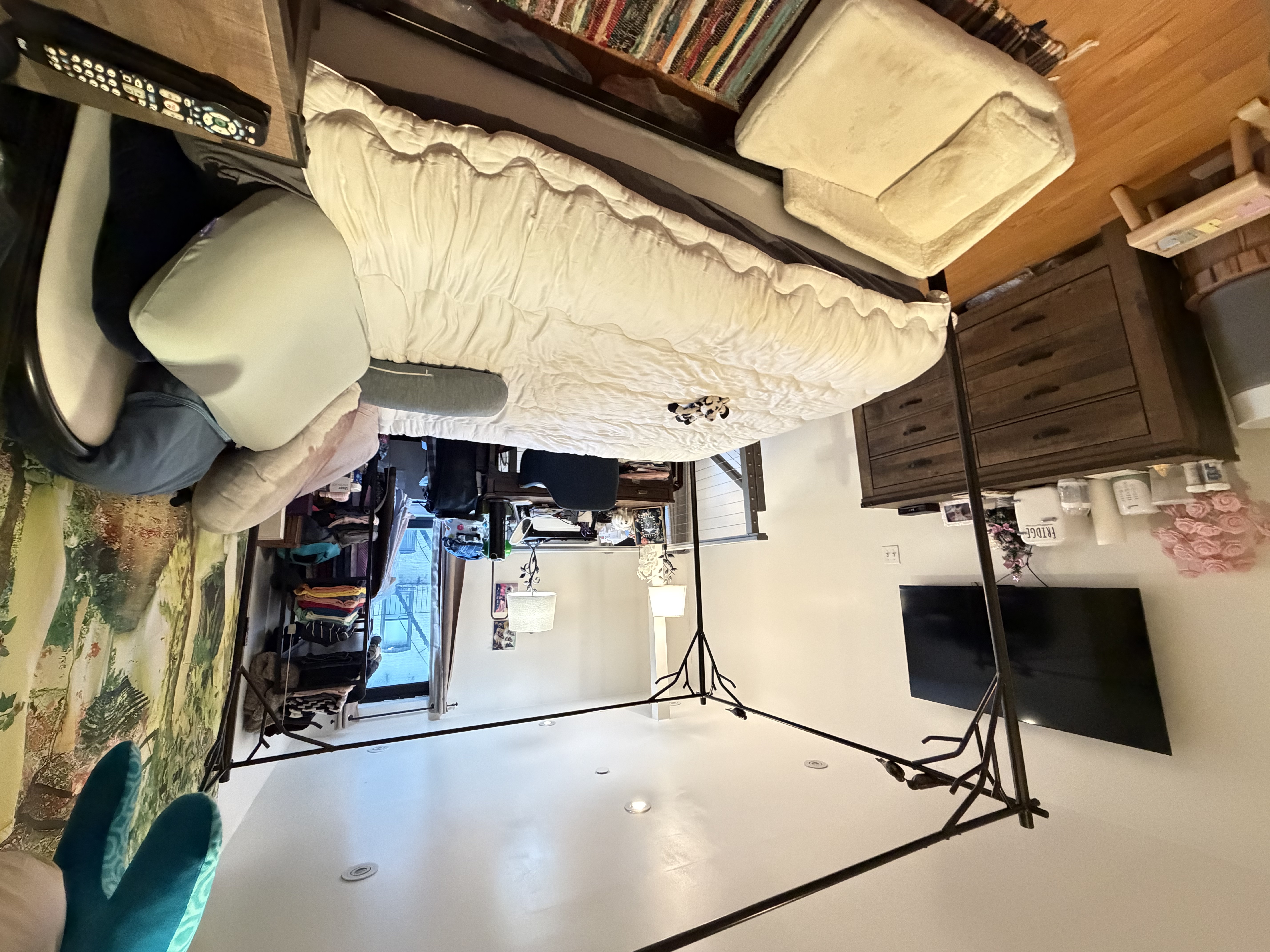 215 East 81st Street, Unit 5E Manhattan, NY 10028 - Photo 4 of 7 a bedroom with a bed and flat screen tv