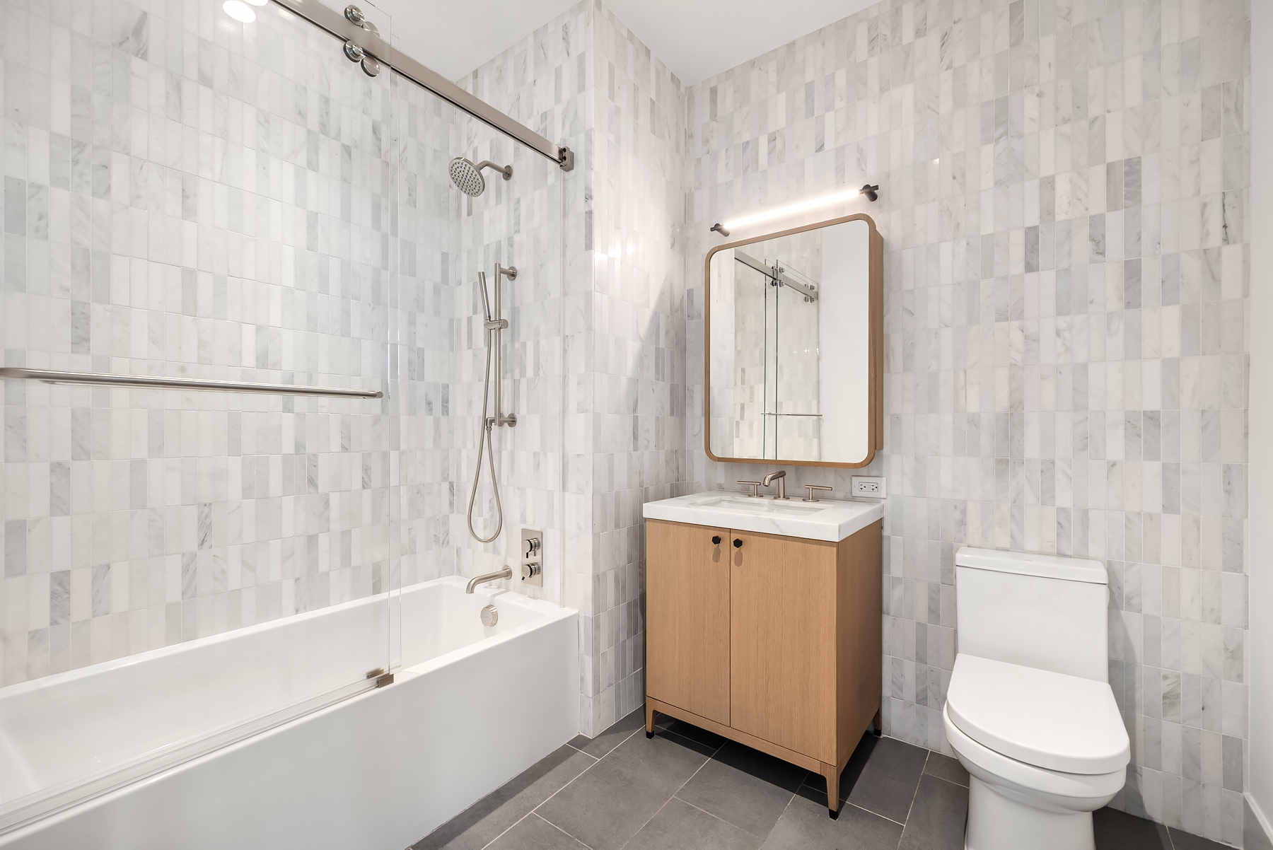 115 York Street, Unit PH20B Brooklyn, NY 11201 - Photo 10 of 21 a bathroom with a granite countertop sink toilet and shower