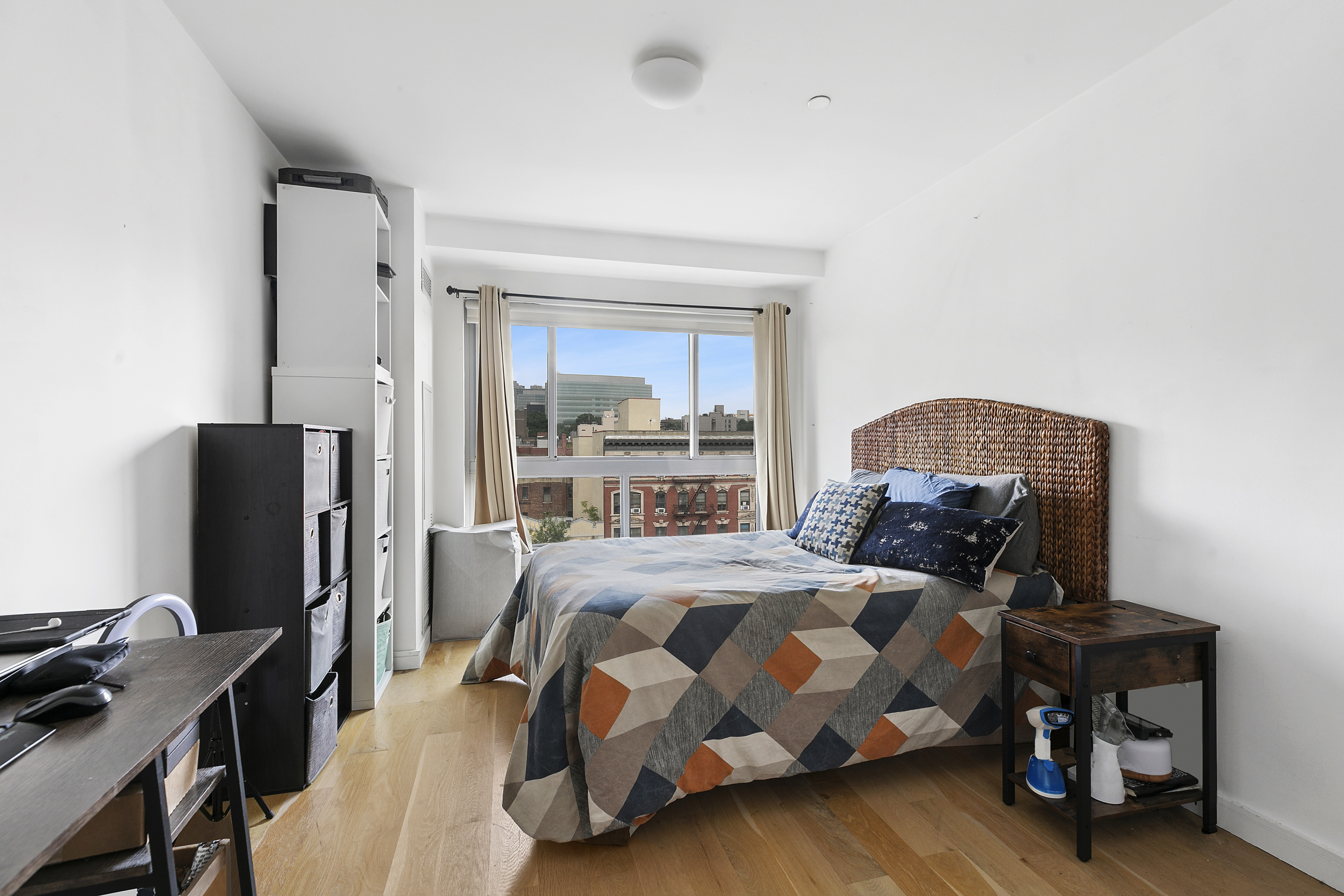 171 West 131st Street, Unit PH3 Manhattan, NY 10027 - Photo 3 of 13 a bedroom with a bed tv and a desk