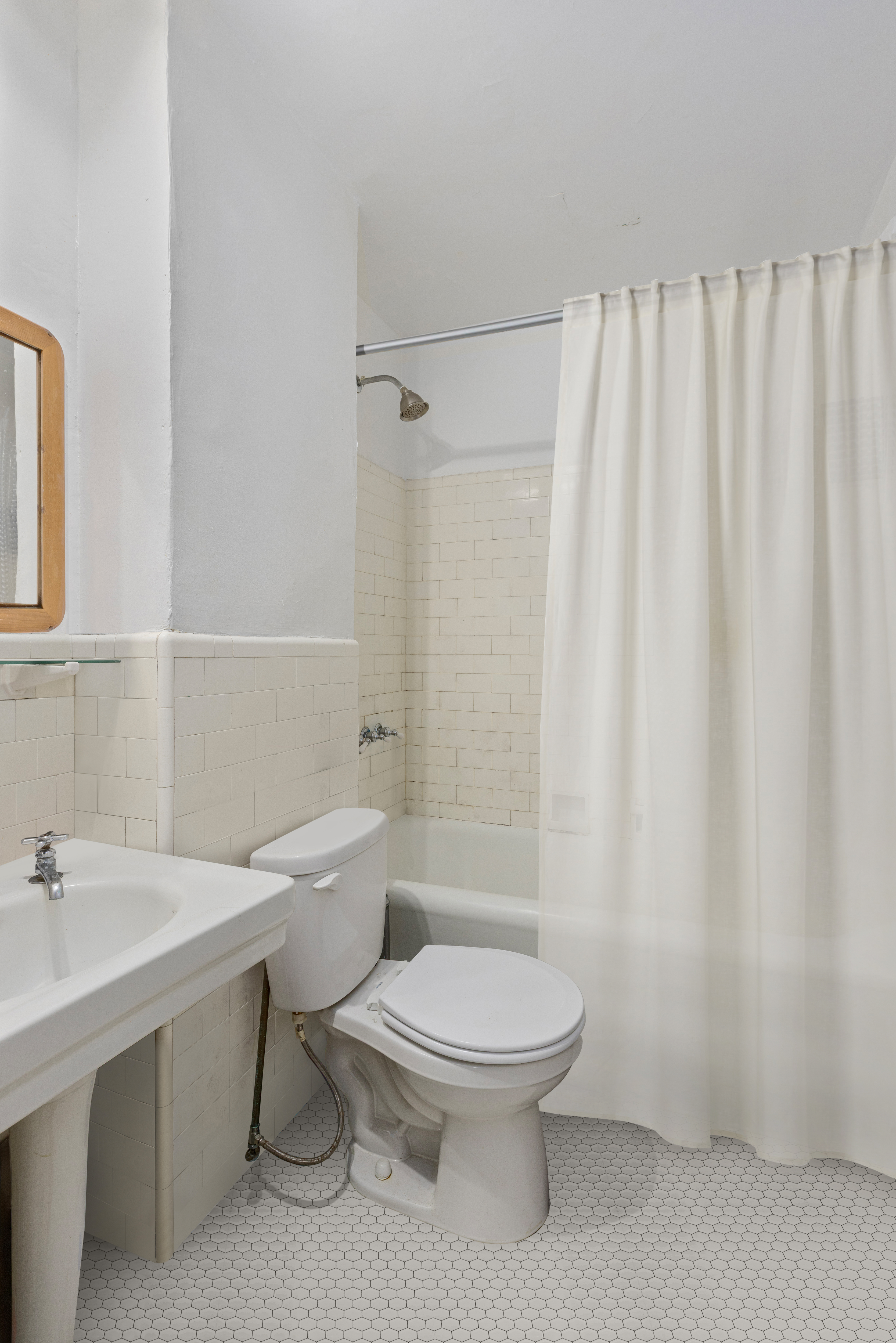 235 West 102nd Street, Unit 5V Manhattan, NY 10025 - Photo 6 of 15 a white toilet sitting next to a bathroom sink