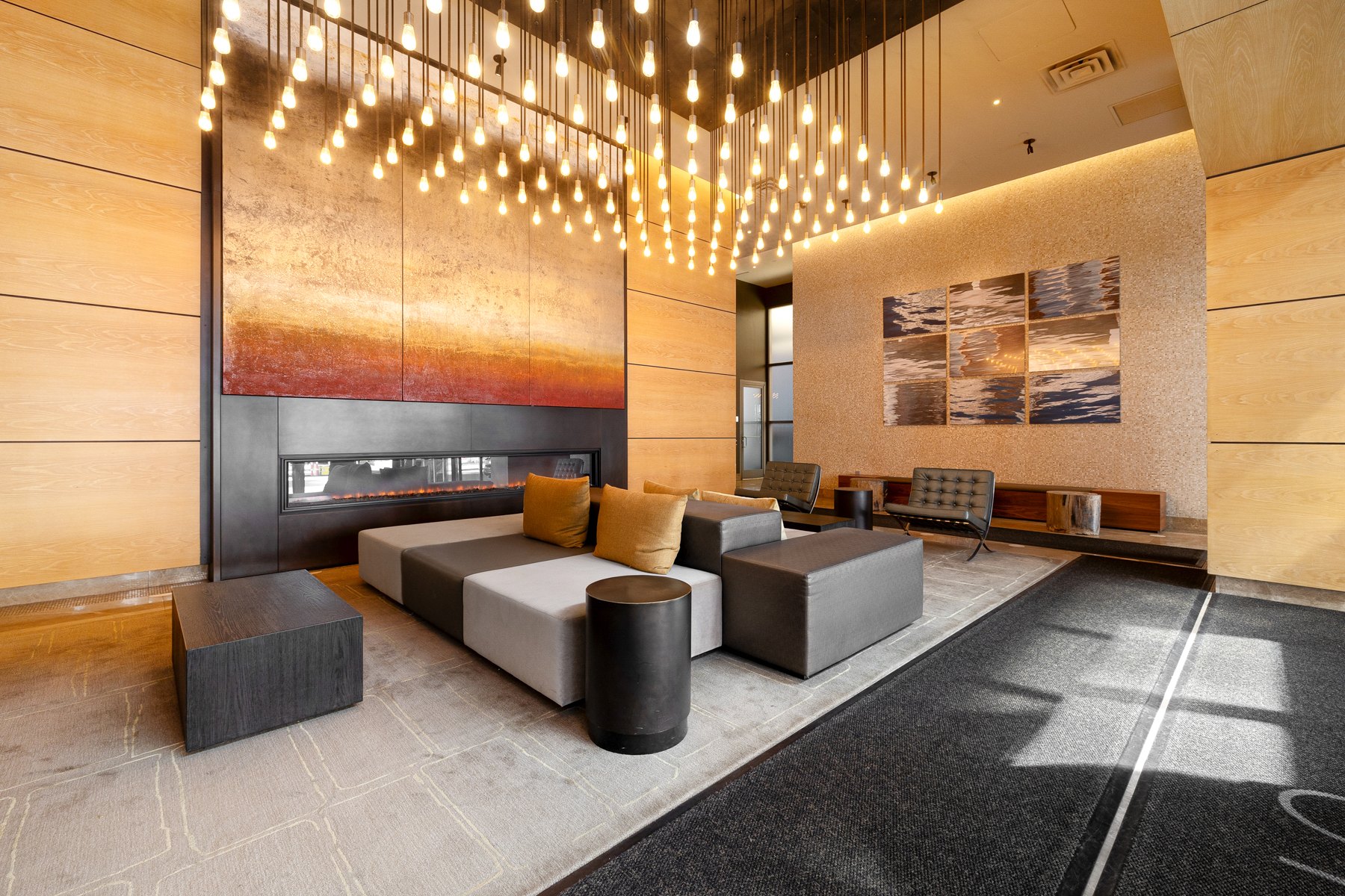 10 West End Avenue, Unit 30C Manhattan, NY 10023 - Photo 18 of 22 a living room with couches and kitchen view with wooden floor