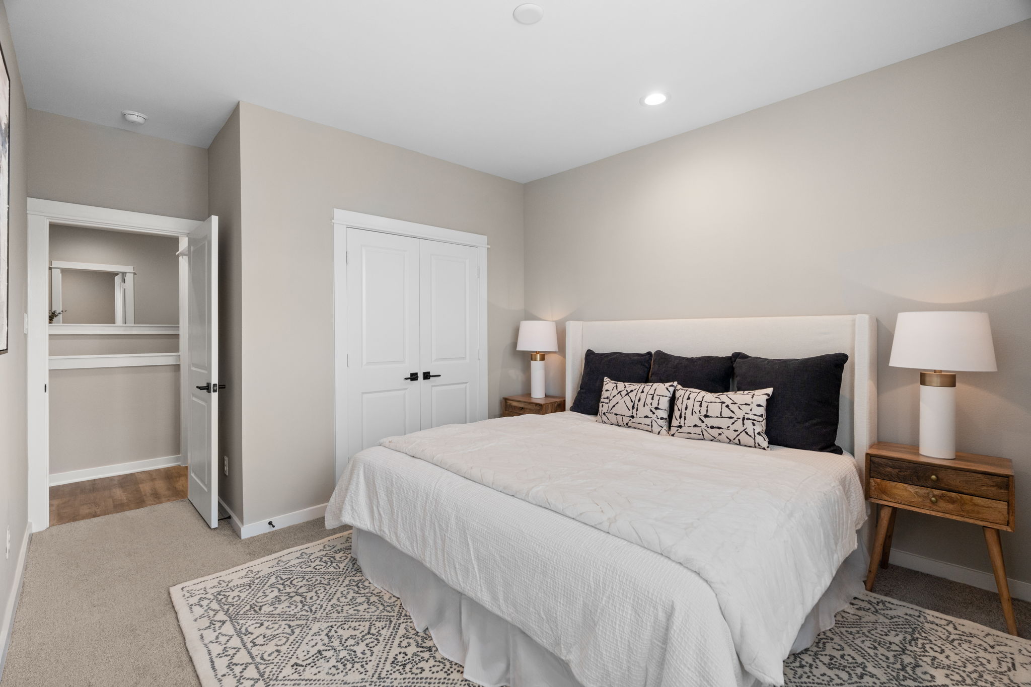 11303 Stonework Grv Lane Houston, TX 77076 - Photo 31 of 39 a bedroom with a bed and a lamp with wooden floor