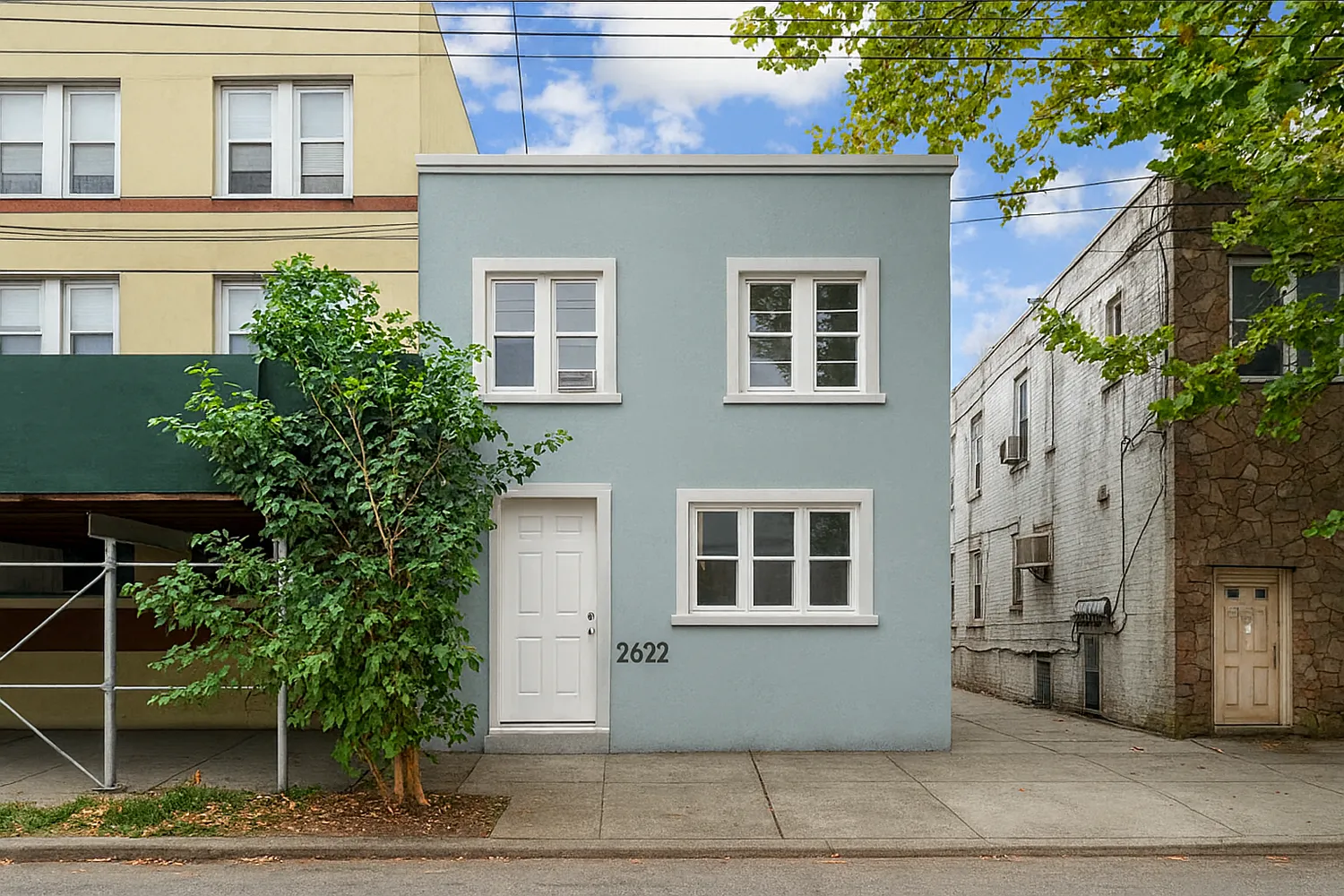 a front view of a house with plants