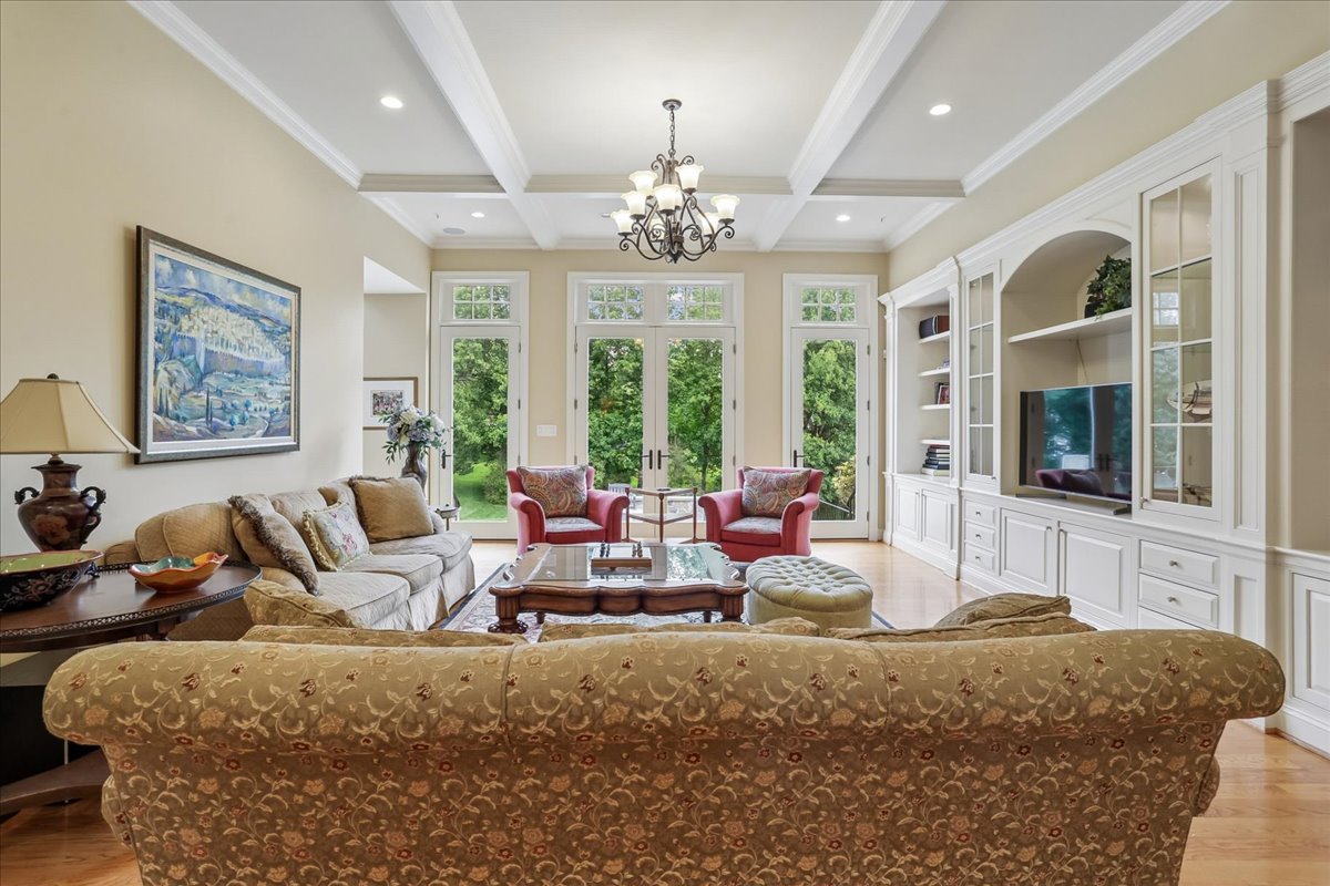 11736 Gainsborough Road Potomac, MD 20854 - Photo 25 of 90 a living room with furniture or chandelier and a fireplace
