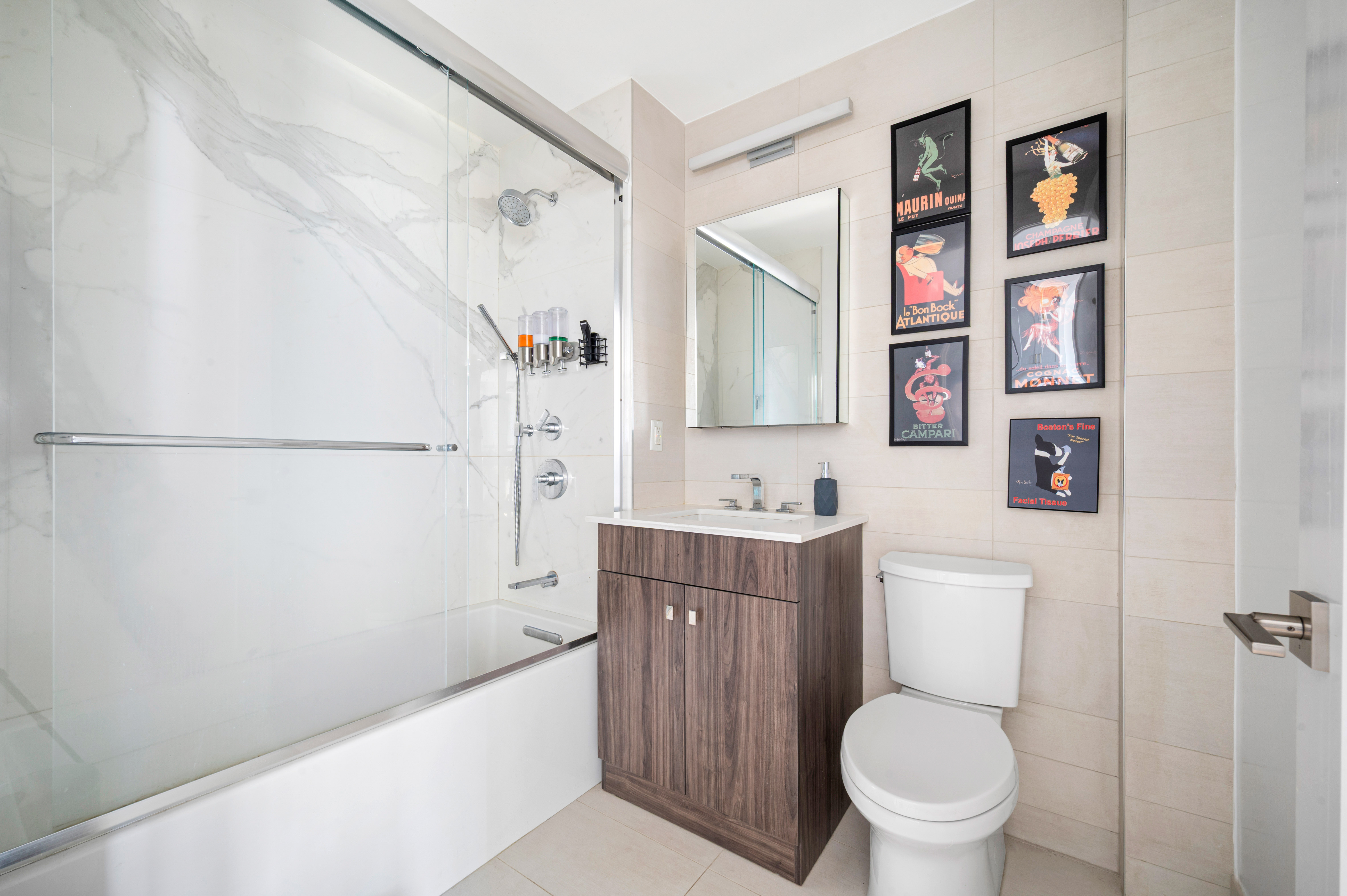23-43 31st Road, Unit 3C Queens, NY 11106 - Photo 5 of 10 a bathroom with a toilet sink and mirror